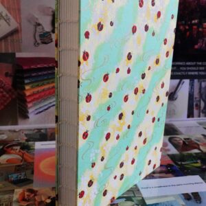 ladybird green - watercolour book - coptic stitch (single thread)