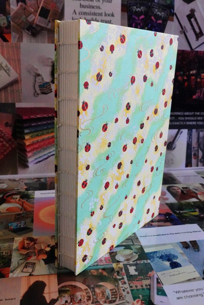 ladybird green - watercolour book - coptic stitch (single thread)
